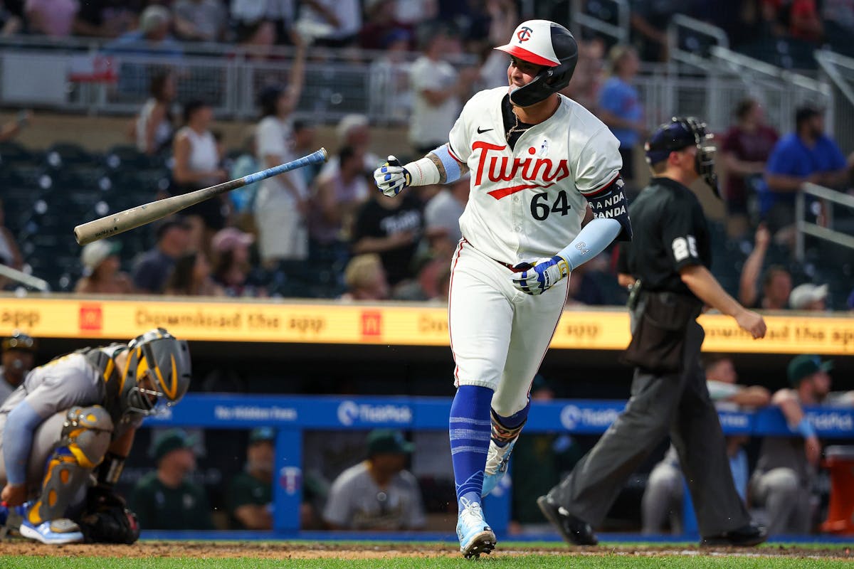 The Twins' Jose Miranda tosses aside his bat after his tiebreaking eighth-inning home run in Game 2 of Sunday's doubleheader with the Athletics at Tar