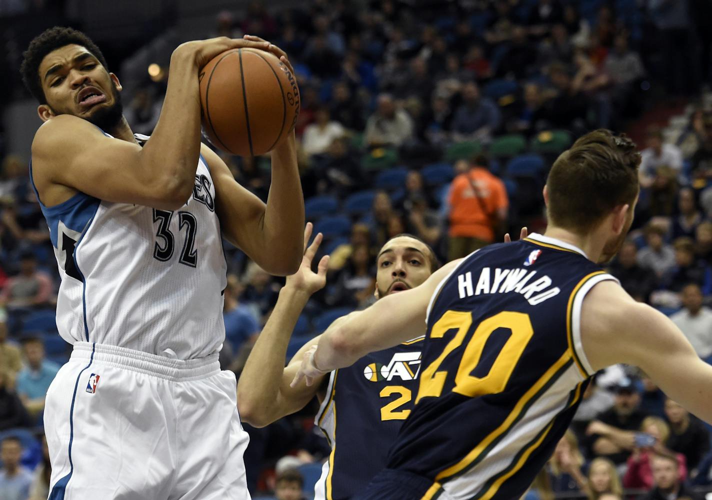 Minnesota Timberwolves&#x2019; Karl-Anthony Towns (32) grabs a rebound against Utah Jazz&#x2019;s Rudy Gobert, of France, and Gordon Hayward (20) during the first quarter of an NBA basketball game on Saturday, April 26, 2016, in Minneapolis. (AP Photo/Hannah Foslien)