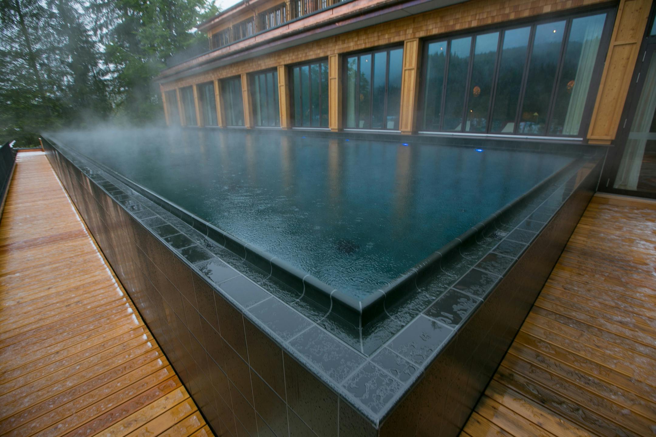 A heated outdoor spa pool sits on decking outside the Schloss Elmau hotel. MUST CREDIT: Bloomberg photo by Krisztian Bocsi.