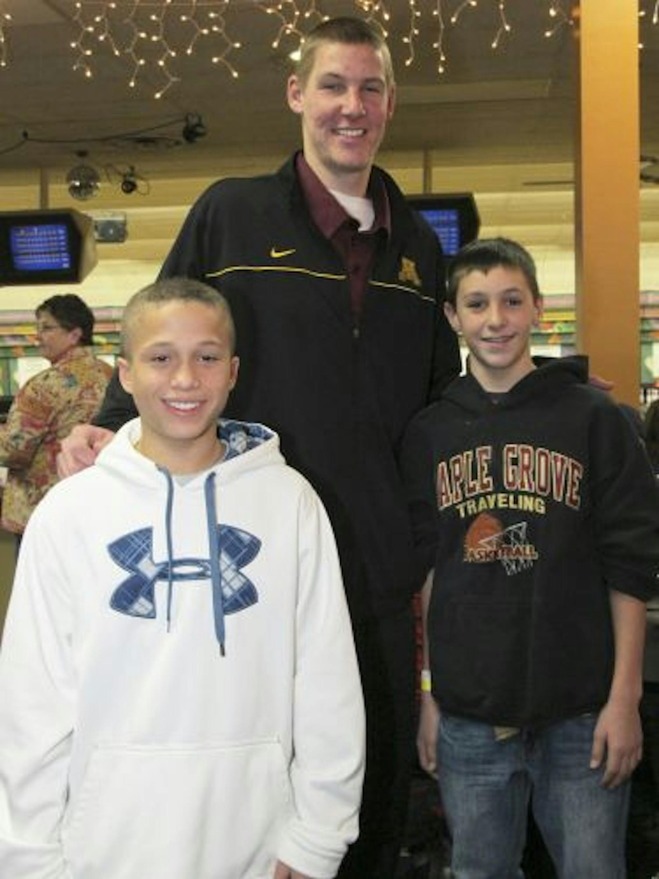 University of Minnesota basketball player Colton Iverson with Isaac Collins and Jake Sitarz.