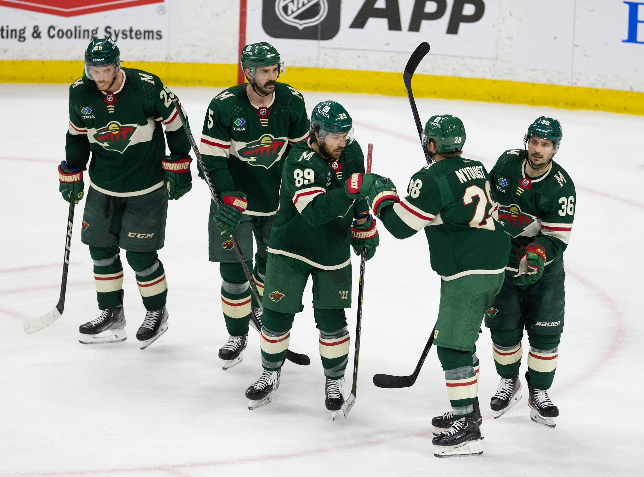 Minnesota Wild center Frederick Gaudreau (89) is congratulated by teammates, including Minnesota Wild center Gustav Nyquist (28) after he backhanded a shot past Dallas Stars goaltender Jake Oettinger (29) in the third period.