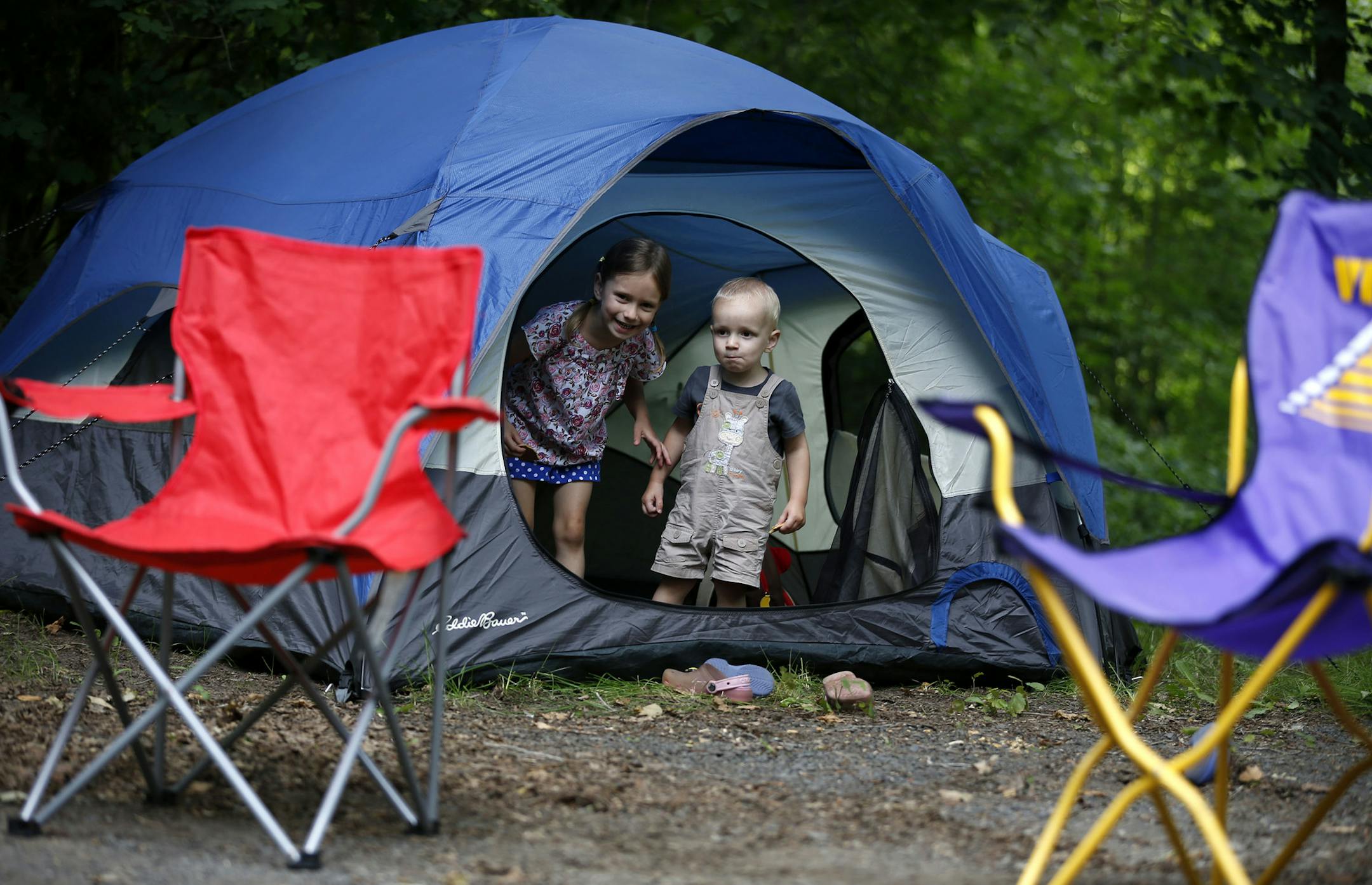 Siblings Abby Ericson, 5, and Zach Ericson, 20 months, peek out of their tent at the Riverway campground at William O'Brien State Park on Thursday afternoon.] MONICA HERNDON monica.herndon@startribune.com Marine on St. Croix, MN 07/3/2014