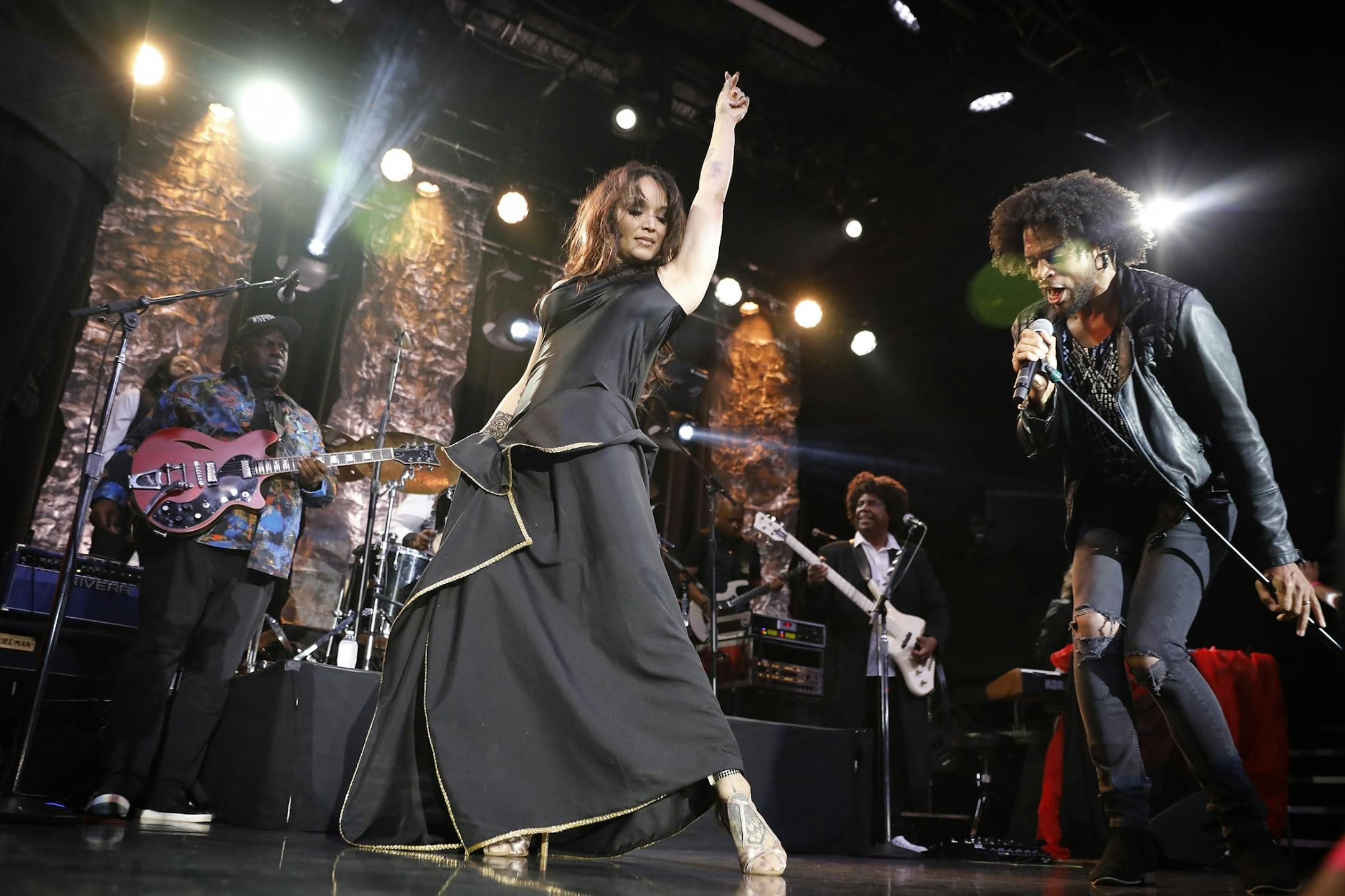 Mayte Garcia, center, makes a guest appearance during the New Power Generation show as MacKenzie, right, sings.