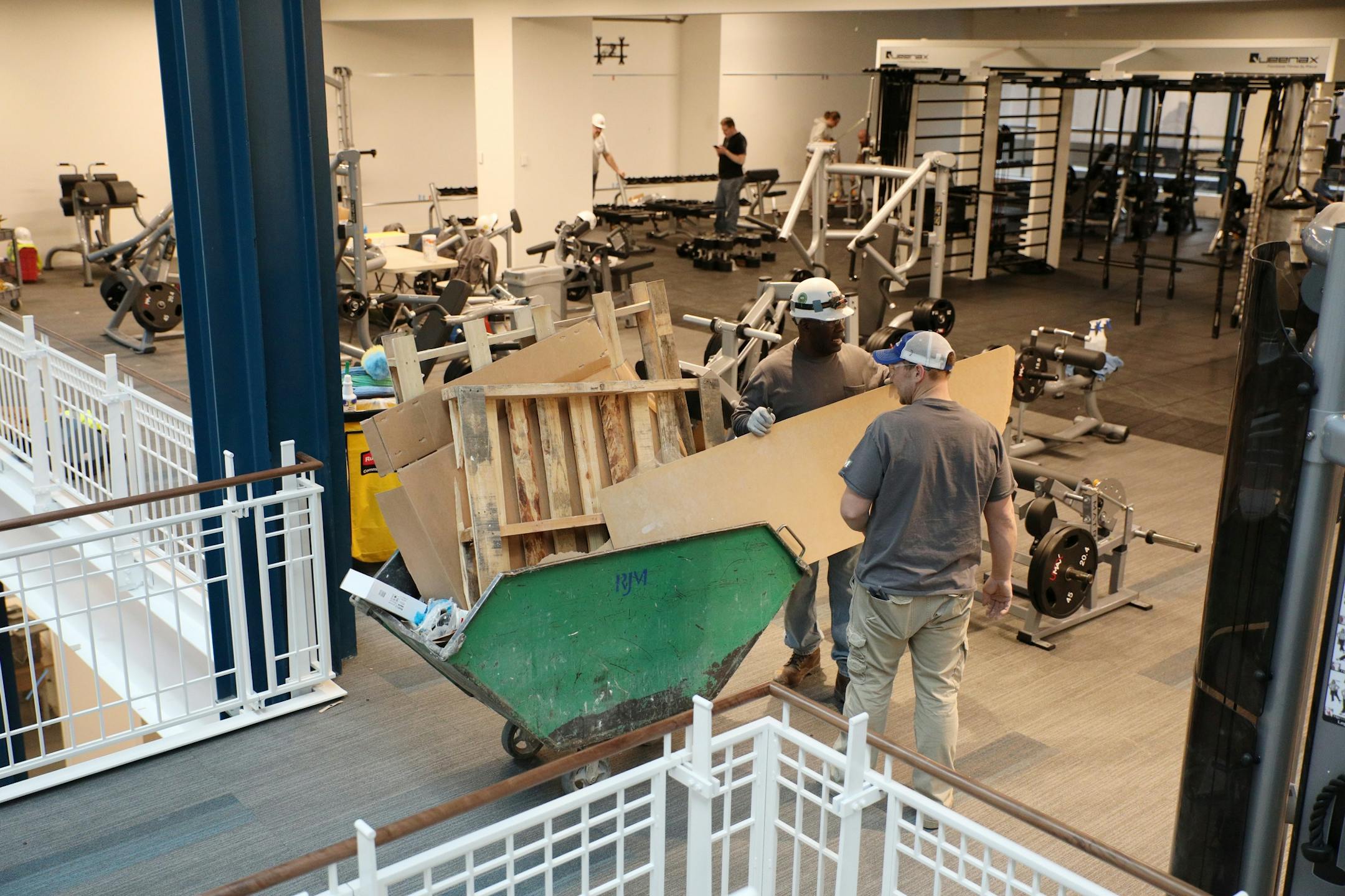 Construction workers worked near the weight area.