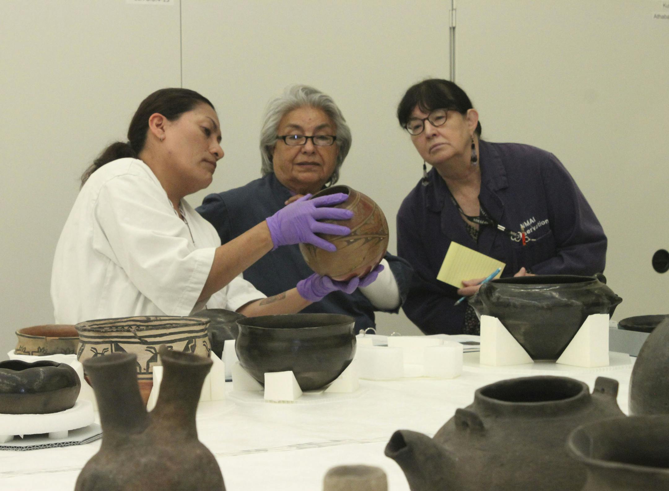 Staff from the Pueblo of Pojoaque’s Poeh Cultural Center and Museum as well as artists from the Pueblo of Pojoaque begin facilitating a long-term collections loan at the National Museum of the American Indian. Provided photo. Smithsonian Institution