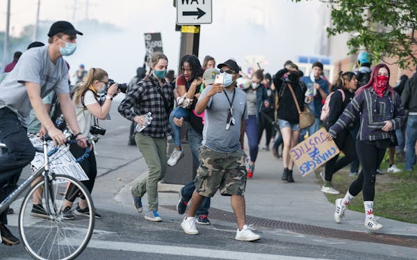 Protesters fled as police moved in aggressively with tear gas during a peaceful protest outside the Fifth Precinct headquarters in Minneapolis on Satu
