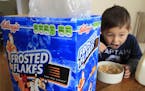 FILE - Nathaniel Donaker, 4, eats Kellogg's Frosted Flakes cereal at his home in Palo Alto, Calif., Thursday, April 28, 2011. Tony the Tiger and Touca