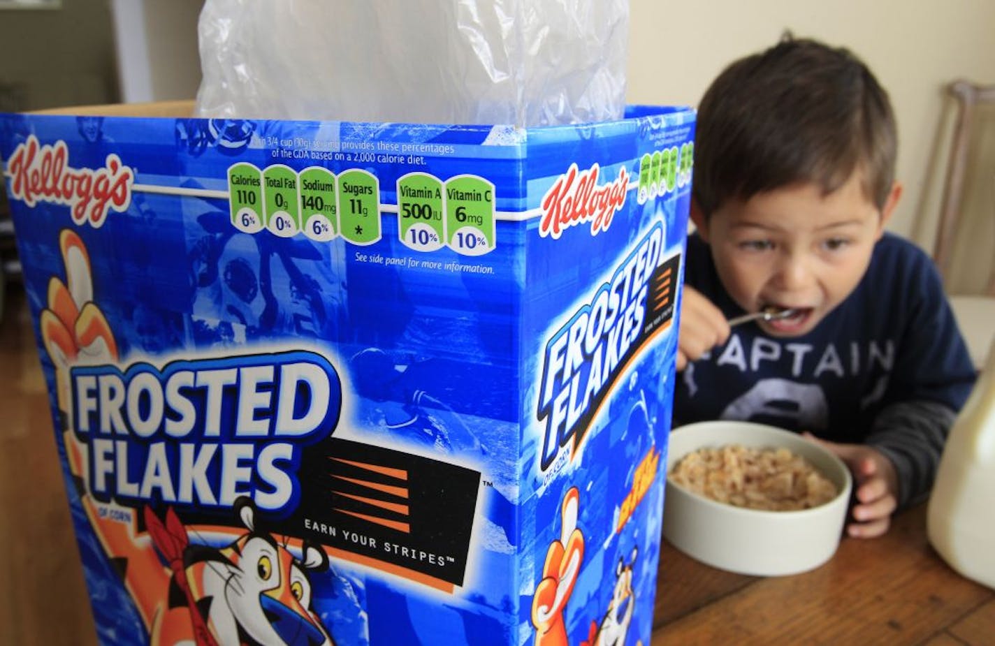 FILE - Nathaniel Donaker, 4, eats Kellogg's Frosted Flakes cereal at his home in Palo Alto, Calif., Thursday, April 28, 2011. Tony the Tiger and Toucan Sam can rest easy. Government officials fine-tuning guidelines for marketing food to children say they won't push the food industry to get rid of colorful cartoon characters on cereal boxes anytime soon. The food industry, backed by House Republicans, who are holding a hearing on the issue Wednesday, Oct. 12, 2011 has aggressively lobbied against