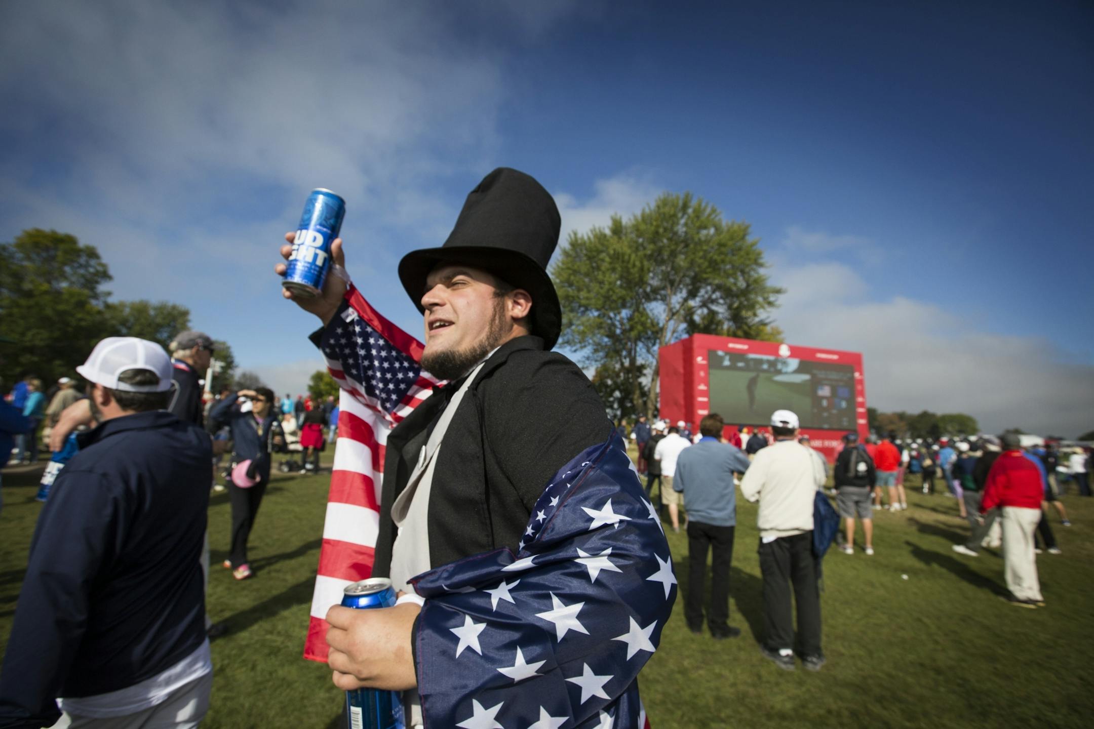 Kyle DeGoey of St. Paul, dressed as Abe Lincoln, cheers on the USA.