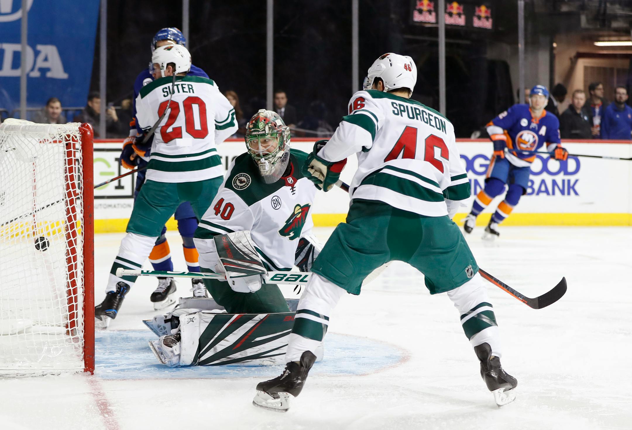 Wild goaltender Devan Dubnyk looked over his shoulder as a goal shot by Islanders defenseman Devon Toews slipped behind him in the second period Sunday, as Wild defensemen Jared Spurgeon (46) and Ryan Suter tried to help.