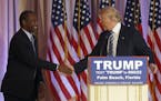Former Republican presidential candidate Ben Carson shakes hands with Republican presidential candidate Donald Trump, after announcing he will endorse