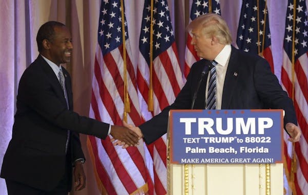 Former Republican presidential candidate Ben Carson shakes hands with Republican presidential candidate Donald Trump, after announcing he will endorse