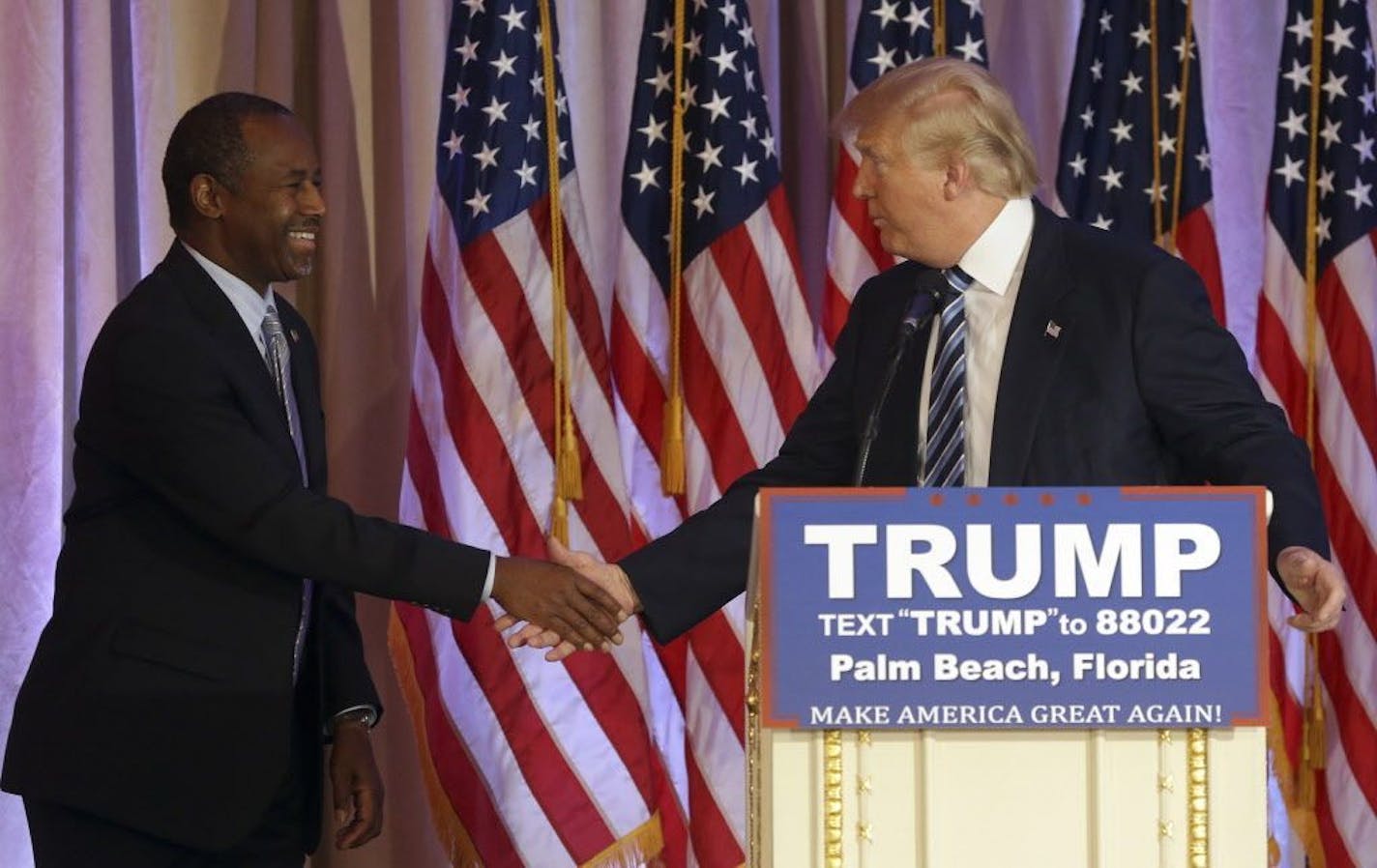 Former Republican presidential candidate Ben Carson shakes hands with Republican presidential candidate Donald Trump, after announcing he will endorse Trump during a news conference at the Mar-A-Lago Club, Friday, March 11, 2016, in Palm Beach, Fla.