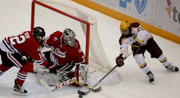 Gophers captain Justin Kloos made his way around the net to try to score against St. Cloud State goalie Charlie Lindgren during the first period on No