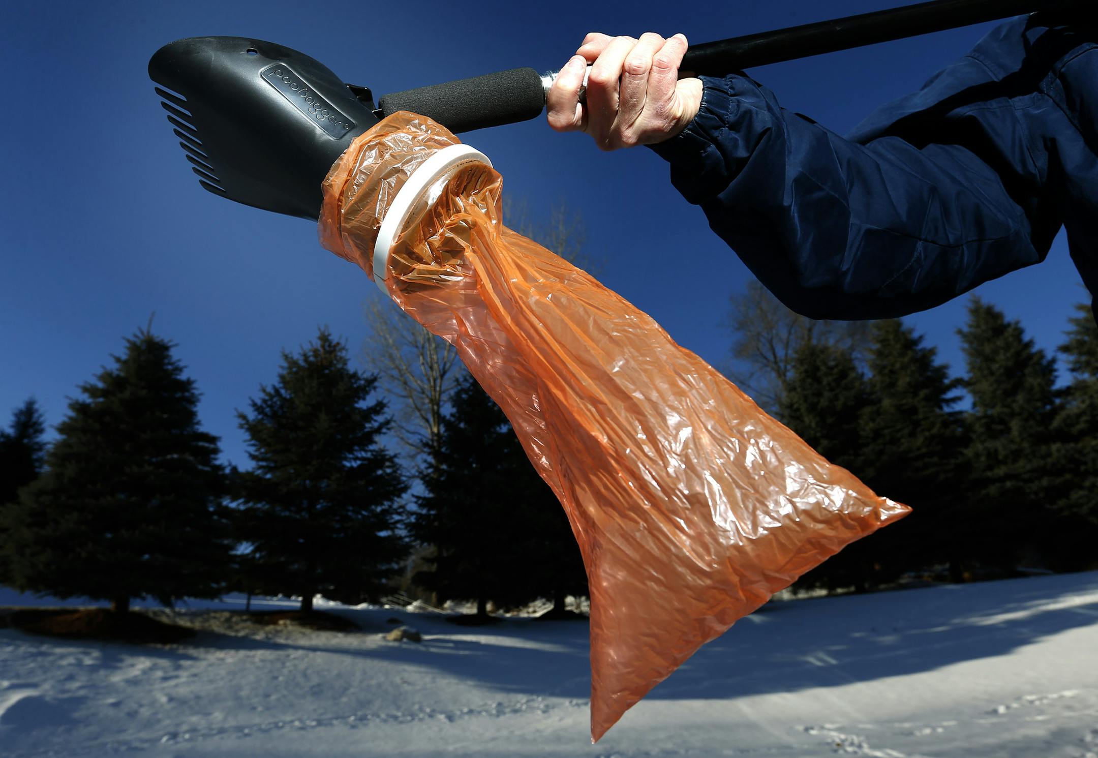Tom Zurn posed with his invention the PooBagger. Wilson got the idea when the family got Wilson, a Tibetan Terrier. ] CARLOS GONZALEZ cgonzalez@startribune.com, January 12, 2015, Eden Prairie, Minn., Tom Zurn, a graphic designer by profession, quit his day job two years after he designed and launched Minnesota made "PooBagger," a plastic tool that scoops up dog poop into a (recycled Star Tribune plastic bag) without having to bend over. He got the idea for what is a $39.99 product (sold online a