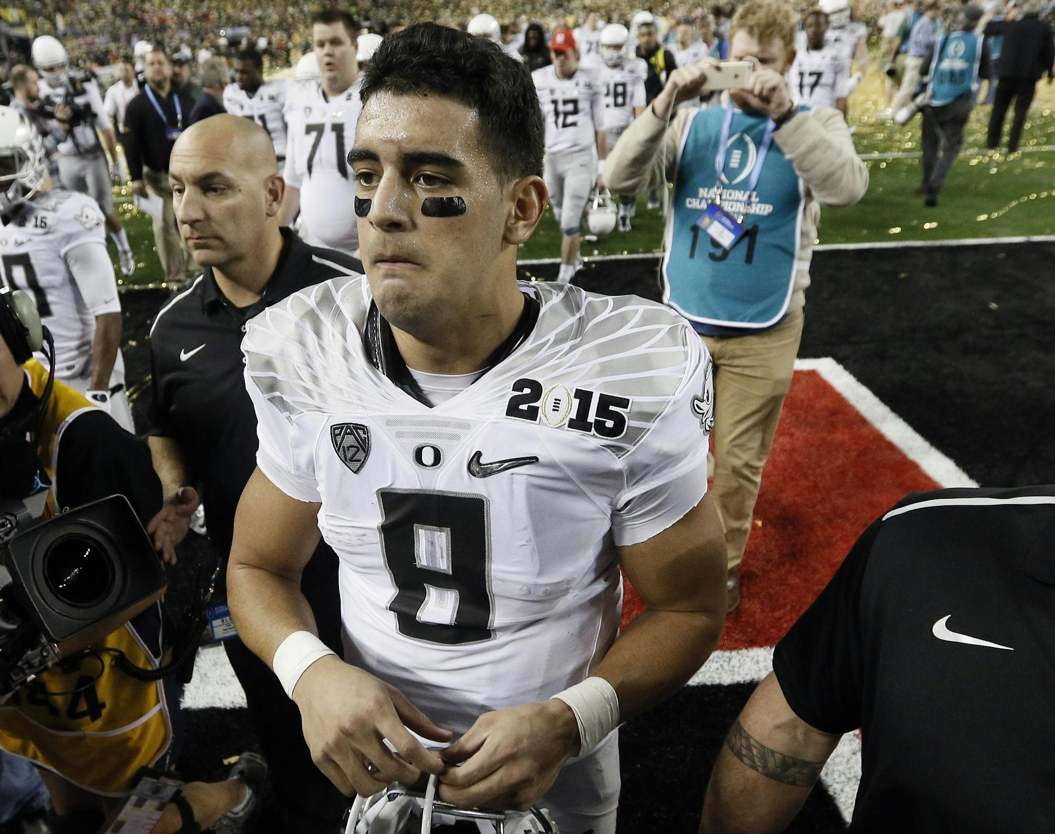 Oregon's Marcus Mariota walks off the field after the NCAA college football playoff championship game against Ohio State Monday, Jan. 12, 2015, in Arlington, Texas. Ohio State won 42-20. (AP Photo/Brandon Wade)