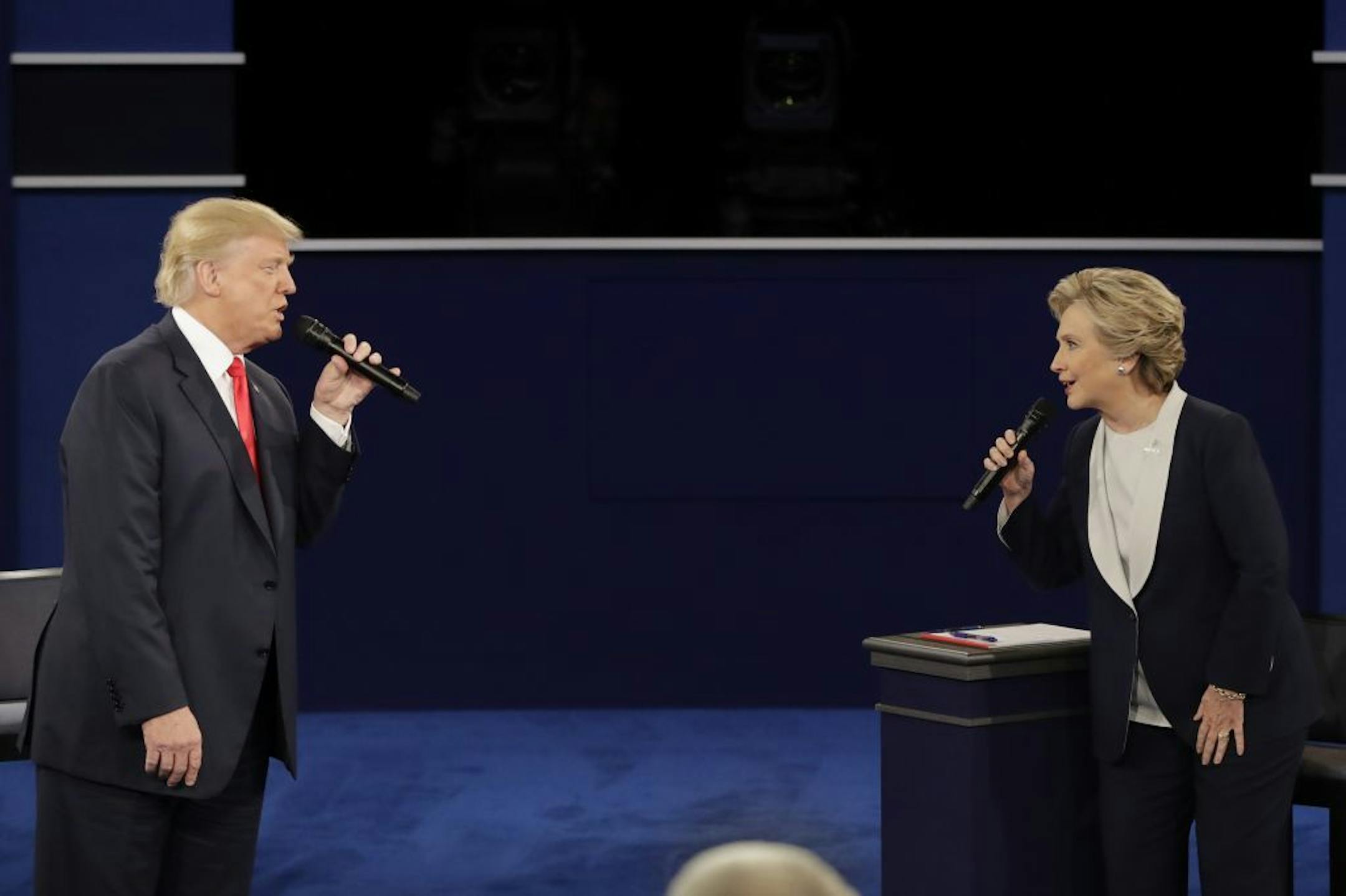 Republican presidential nominee Donald Trump and Democratic presidential nominee Hillary Clinton exchange ideas during the second presidential debate at Washington University in St. Louis, Sunday, Oct. 9, 2016.
