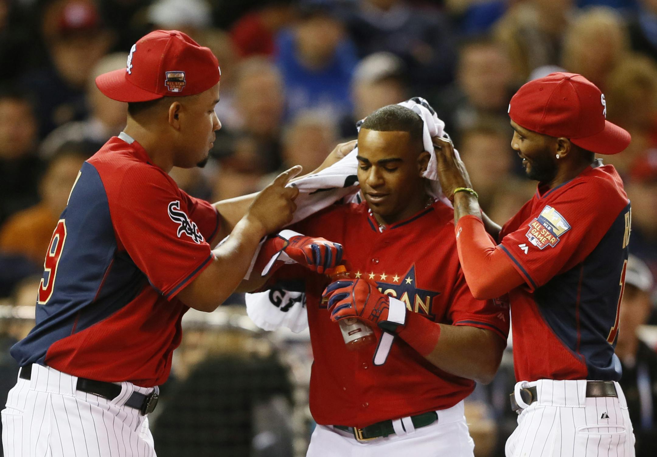 American League, Yoenis Cespedes OAK, gets some help from teammates as he prepared for the finals of the home run derby at Target Field Monday July 14, 2014 in Minneapolis, MN. ] Jerry Holt Jerry.holt@startribune.com