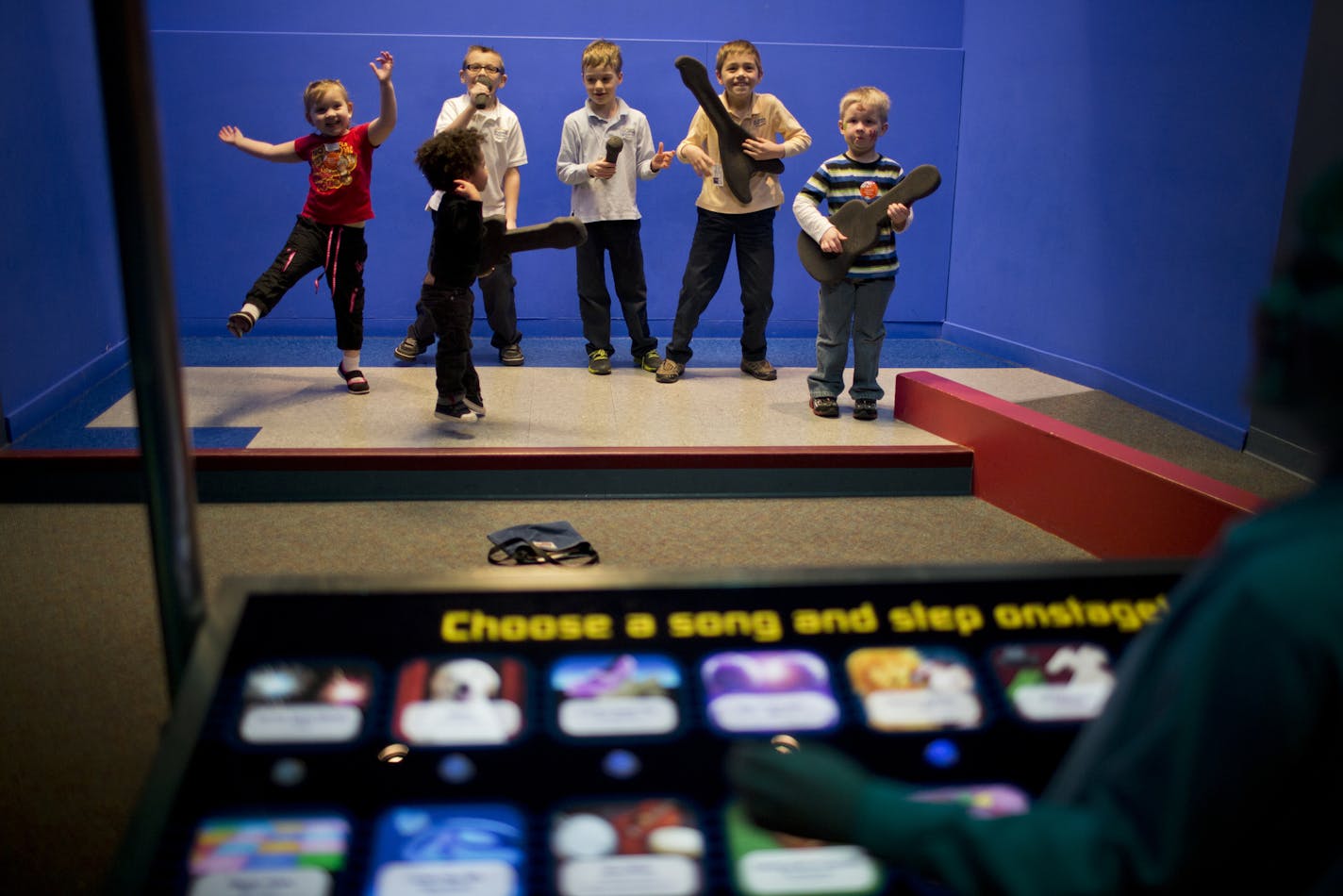 Children danced and sang on a rock-star stage where children can watch themselves light up on a video screen at the science of Museum in St. Paul, Minn., on Friday, April 12, 2013. ] (RENEE JONES SCHNEIDER * reneejones@startribune.com)