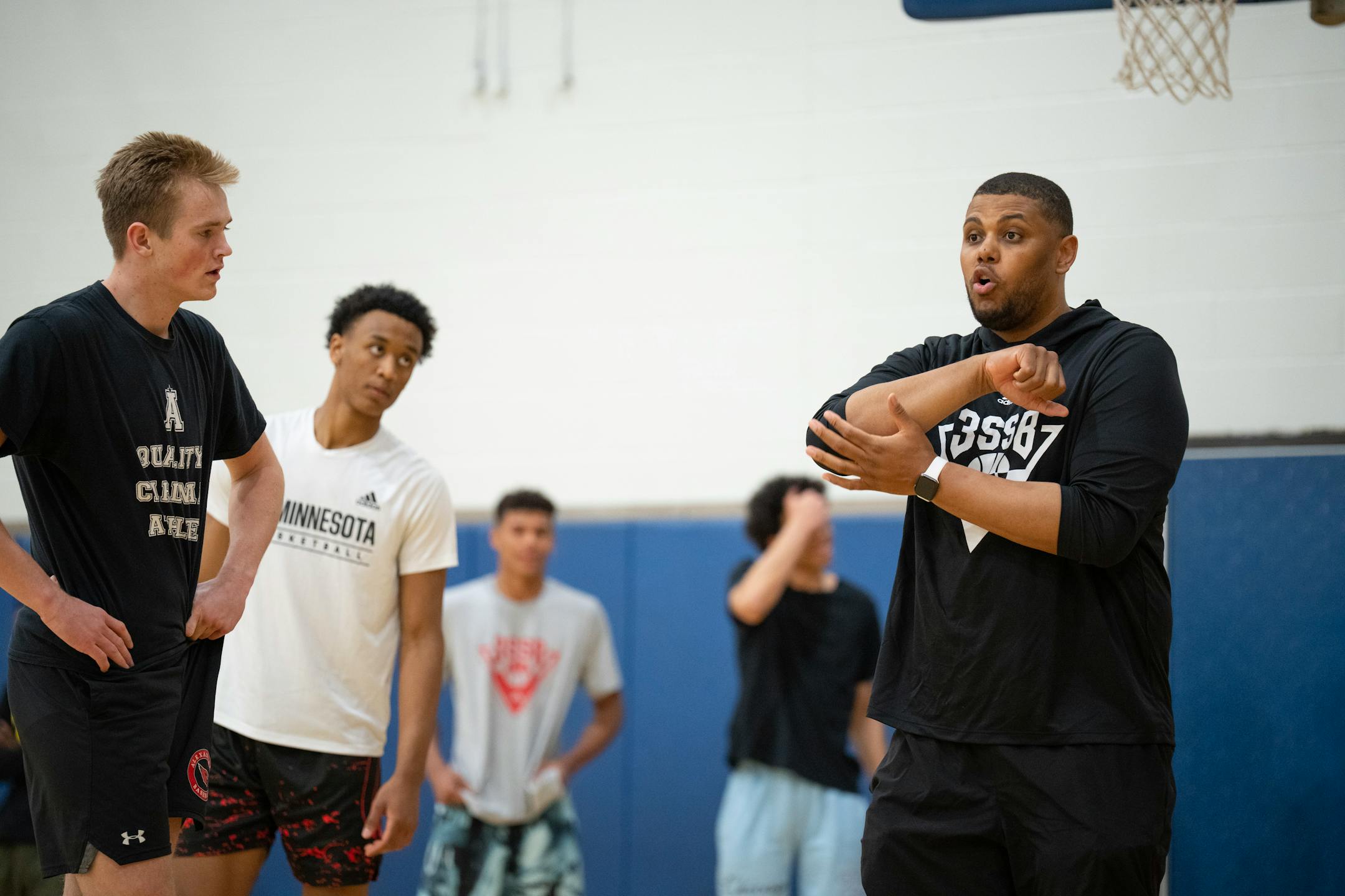 Head coach Jonathan Williams offered a tip for setting a pick to Grayson Grove, left, and during practice at Wayzata Central Middle School in Plymouth.
