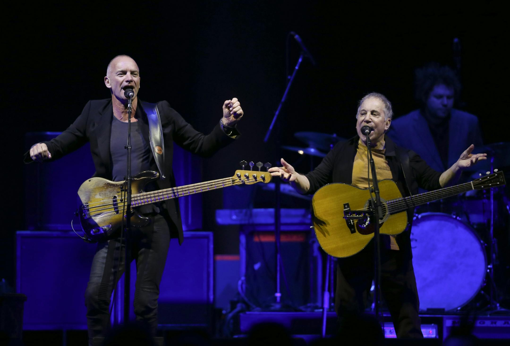 Longtime New York neighbors Sting and Paul Simon decided to hit the road and tour together. The Paul Simon & Sting: On Stage Together tour stopped at Xcel Energy Center in St. Paul Sunday night, February 23, 2014. Sting, left, and Paul Simon performing Sting's song "Brand New Day" to open their set Sunday night at Xcel Energy Center.