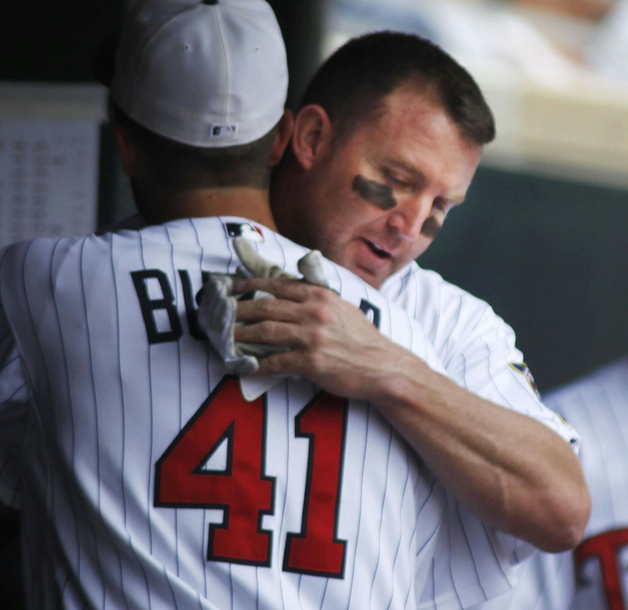 ] The Twins Jim Thome gets a hug from teammate Drew Butera after hitting his first home run of the game in the second inning giving him 573 home runs and tying Harmon Killebrew's all-time Twins home run record. He broke the record with another home run in the fourth inning.