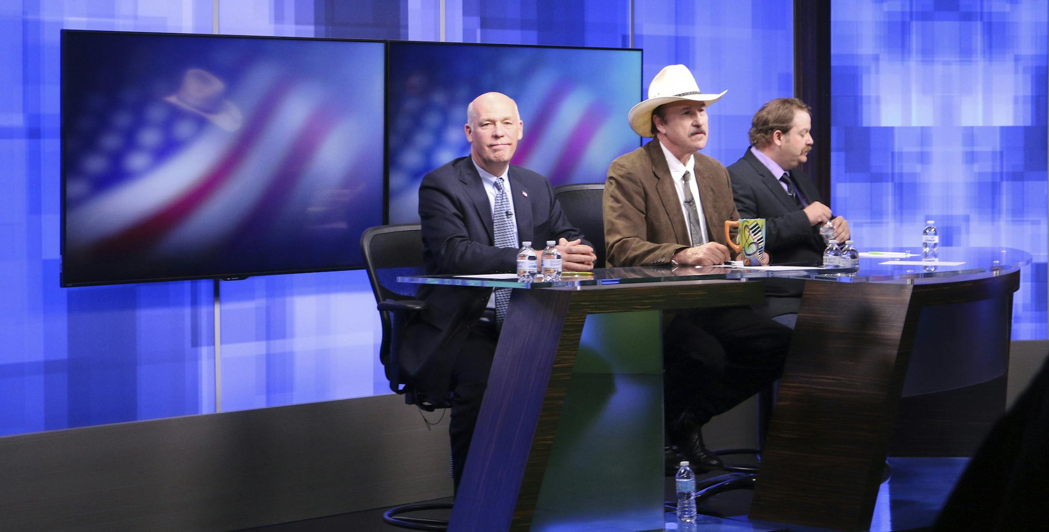 FILE - In this April 29, 2017, file photo, three candidates, from left, Republican Greg Gianforte, Democrat Rob Quist and Libertarian Mark Wicks vying to fill Montana's only congressional seat await the start of their only televised debate in Great Falls, Mont. Montana voters are heading to the polls Thursday, May 25, 2017, to decide a nationally watched congressional election amid uncertainty in Washington over President Donald Trump's agenda and his handling of the country's affairs. (AP Photo