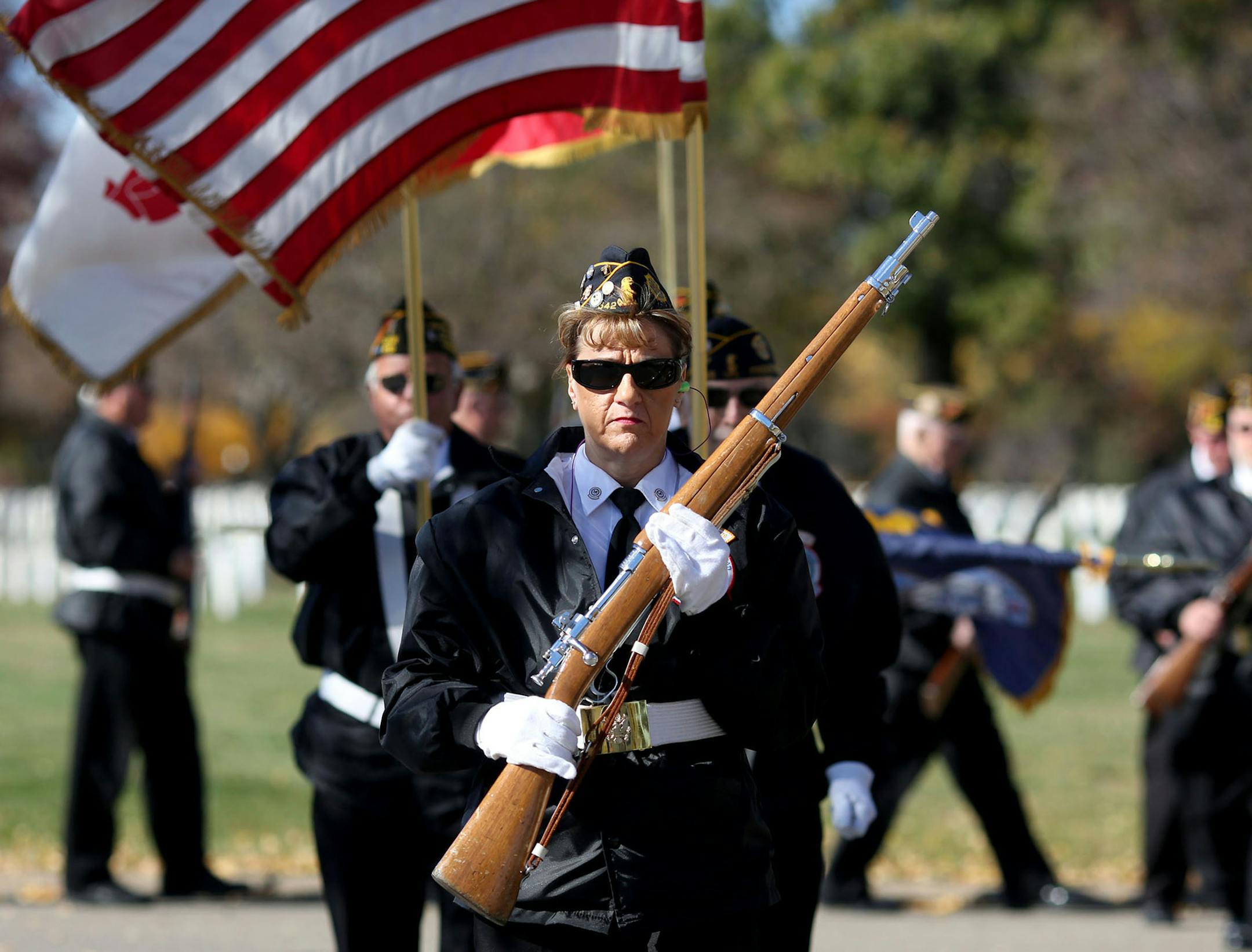 Terri Winter, commander of Fort Snelling National Cemetery's Memorial Rifle Squad, lead the color guard back to the bus after performing at one of nine funerals that day. ] (KYNDELL HARKNESS/STAR TRIBUNE) kyndell.harkness@startribune.com With the Tuesday squad of the Fort Snelling National Cemetery's Memorial Rifle Squad at Fort Snelling in Minneapolis, Min., Tuesday, October 21, 2014.