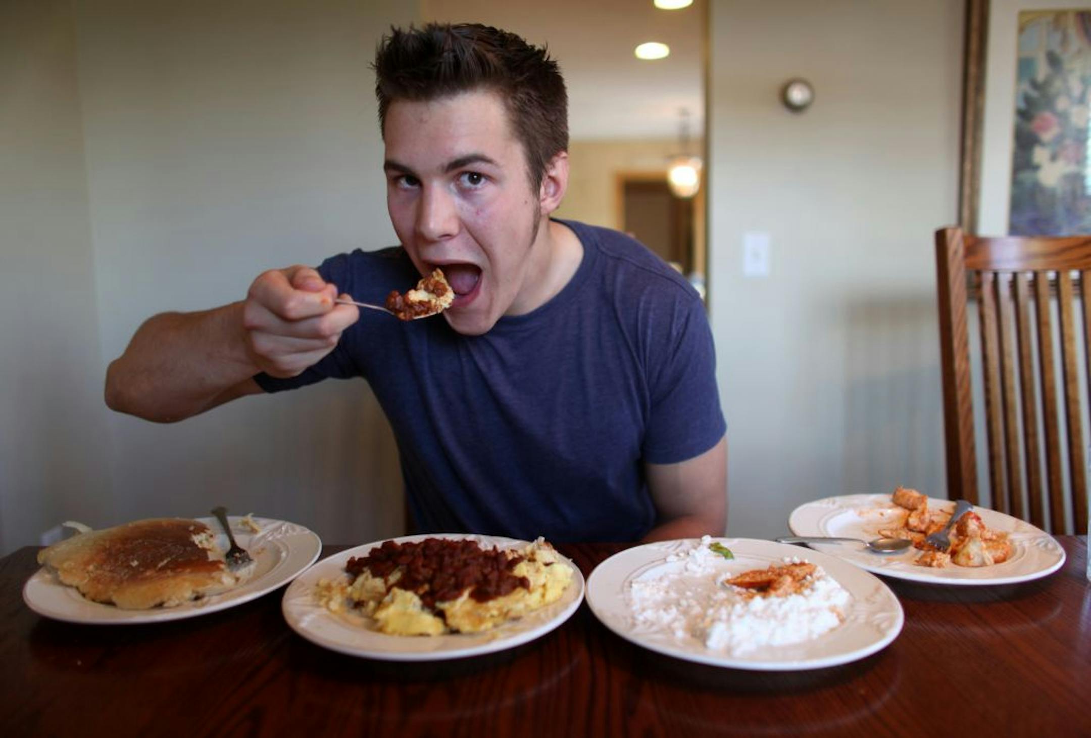 Eric Dahl, the nation's top collegiate competitive eater, digs into his one meal a day: a pancake, chicken, cottage cheese, lettuce, 10 eggs, 10 egg whites and chili, for a total of 2,800 calories.