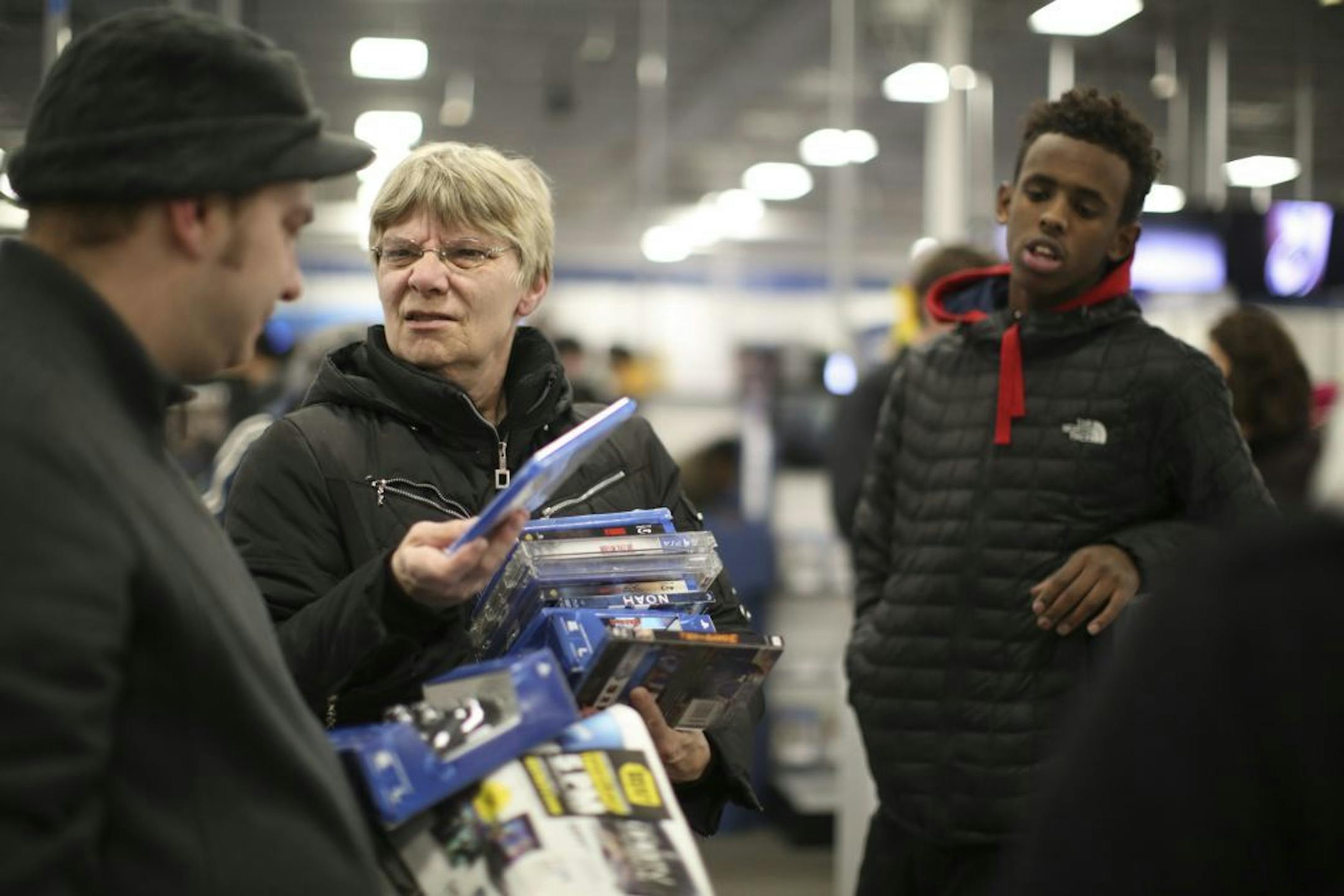 Renee and Anthony Gritche of St. Paul discussed their movie purchases as they waiting in the checkout line Thursday evening at the Best Buy store in Roseville.