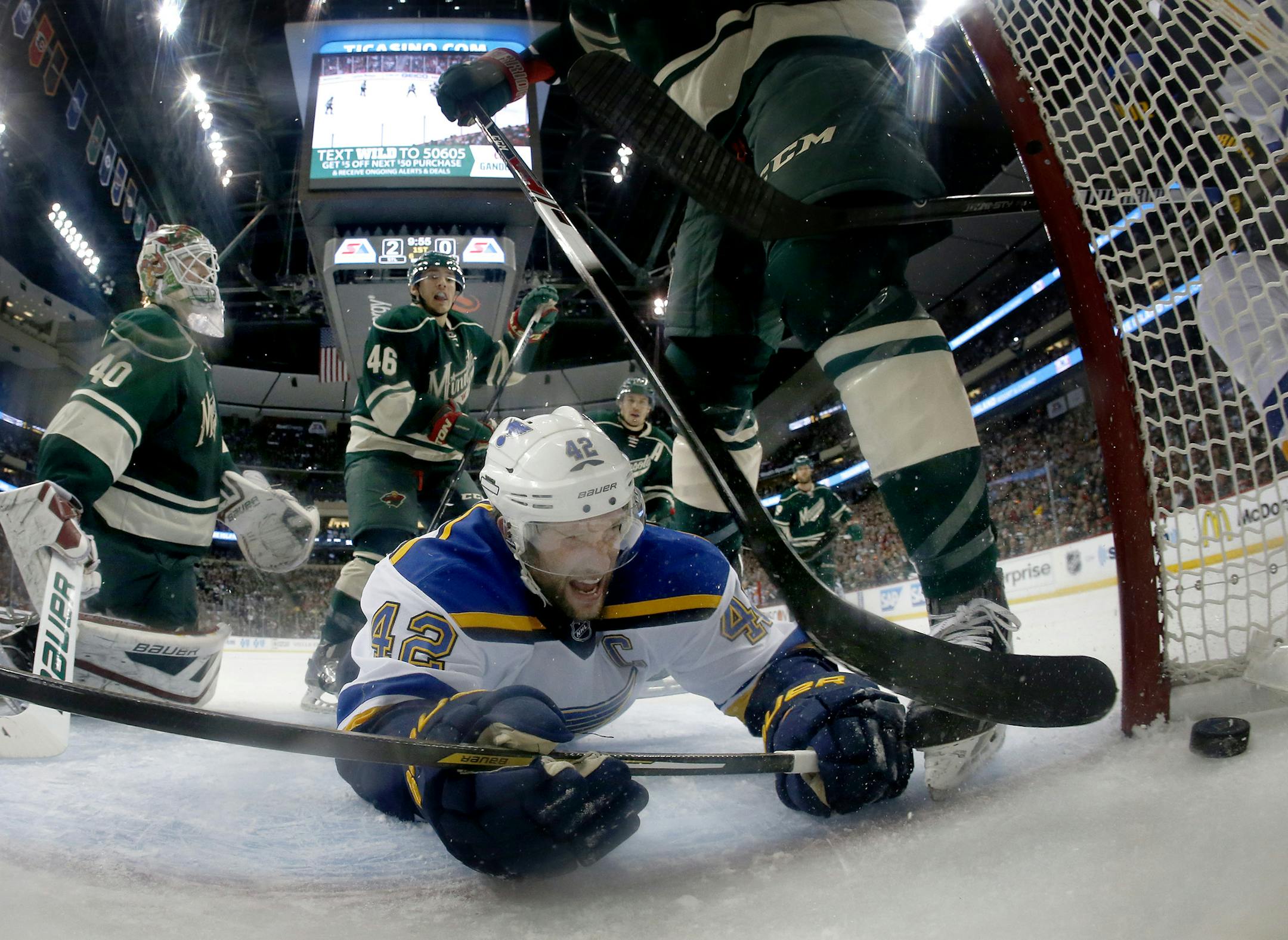 David Backes (42) of the St. Louis Blues crashed into the net after shooting the puck past Minnesota Wild goalie Devan Dubnyk (40) for a goal in the first period. St. Louis Blues beat Minnesota by a final score of 6-1. ] CARLOS GONZALEZ cgonzalez@startribune.com, April 22, 2015, St. Paul, Minn., Xcel Energy Center, NHL, Minnesota Wild vs. St. Louis Blues, Game 4, Stanley Cup Playoffs