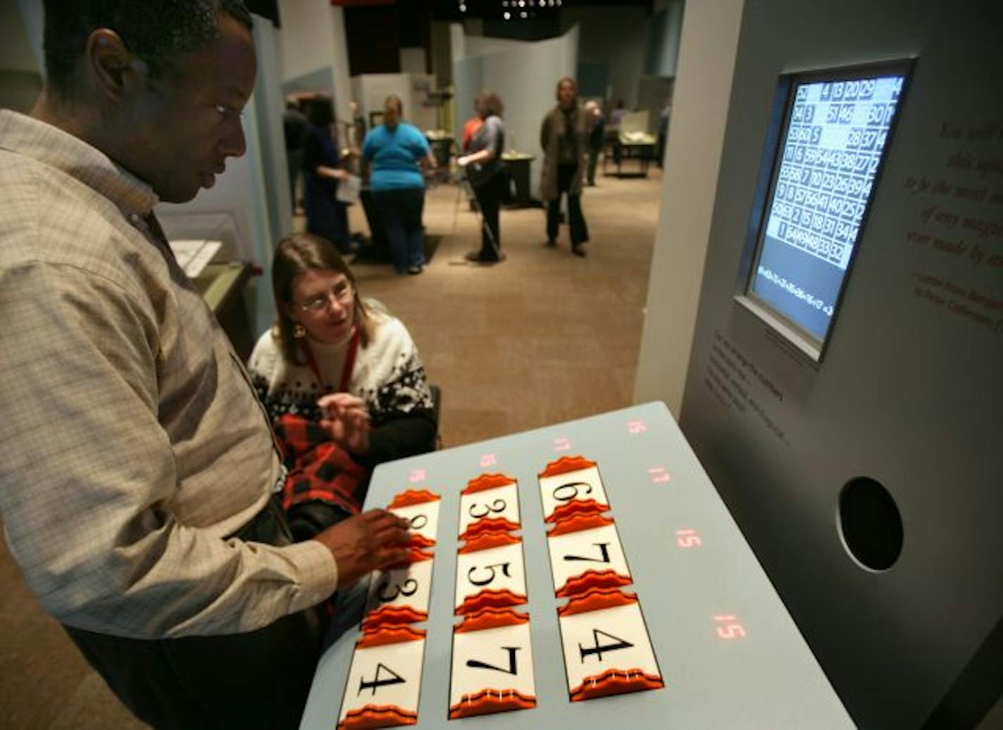 Dwight Scott of St. Paul and Janie Hall of St. Paul played with a display called "Magic Squares" at the Minnesota History Center in St. Paul, MN.