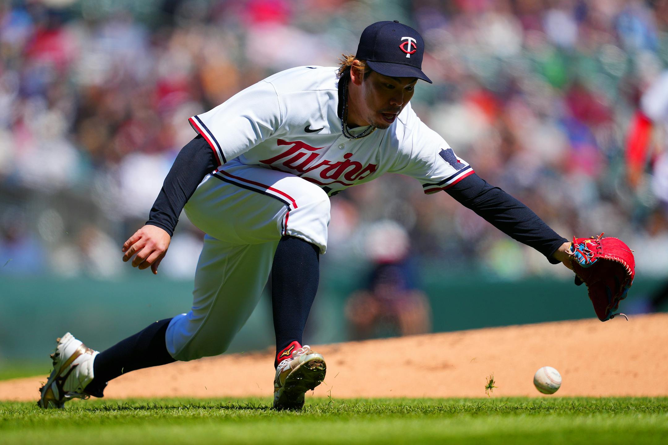 Minnesota Twins starting pitcher Kenta Maeda (18) extends himself as he tries to field a single hit by New York Yankees center fielder Isiah Kiner-Falefa (12) in the second inning.