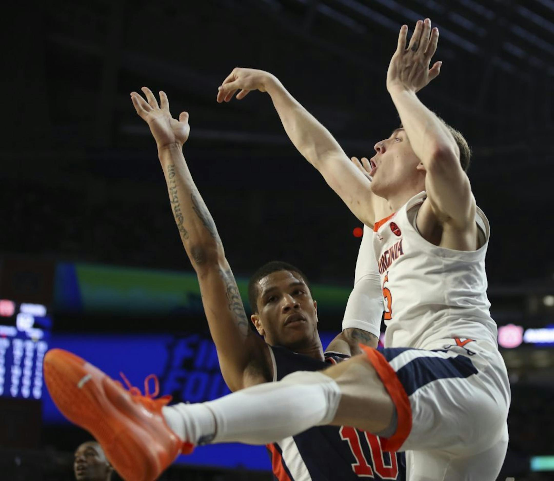 Auburn guard Samir Doughty (10) fouled Virginia Cavaliers guard Kyle Guy (5) while he made a three point attempt with less than a second left on the clock. Guy made all three free throws to win the game for Virginia.