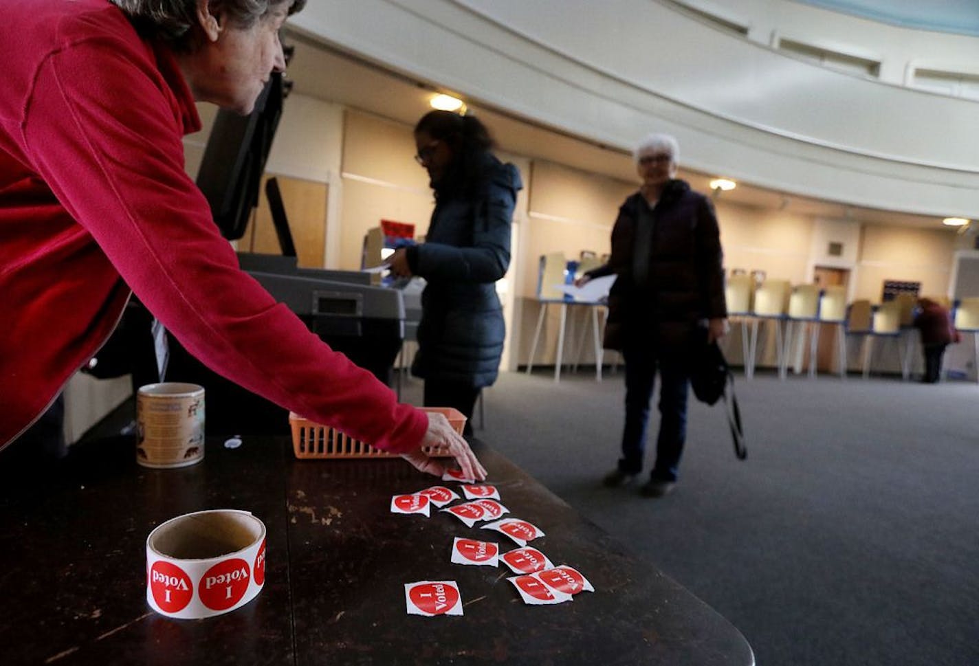 Volunteer poll worker Joan Kvidera prepares "I voted," stickers to hand out to voters casting their ballot at First Congregation Church during Minnesota's first presidential primary in decades Tuesday, March 3, 2020 in Minneapolis, MN.