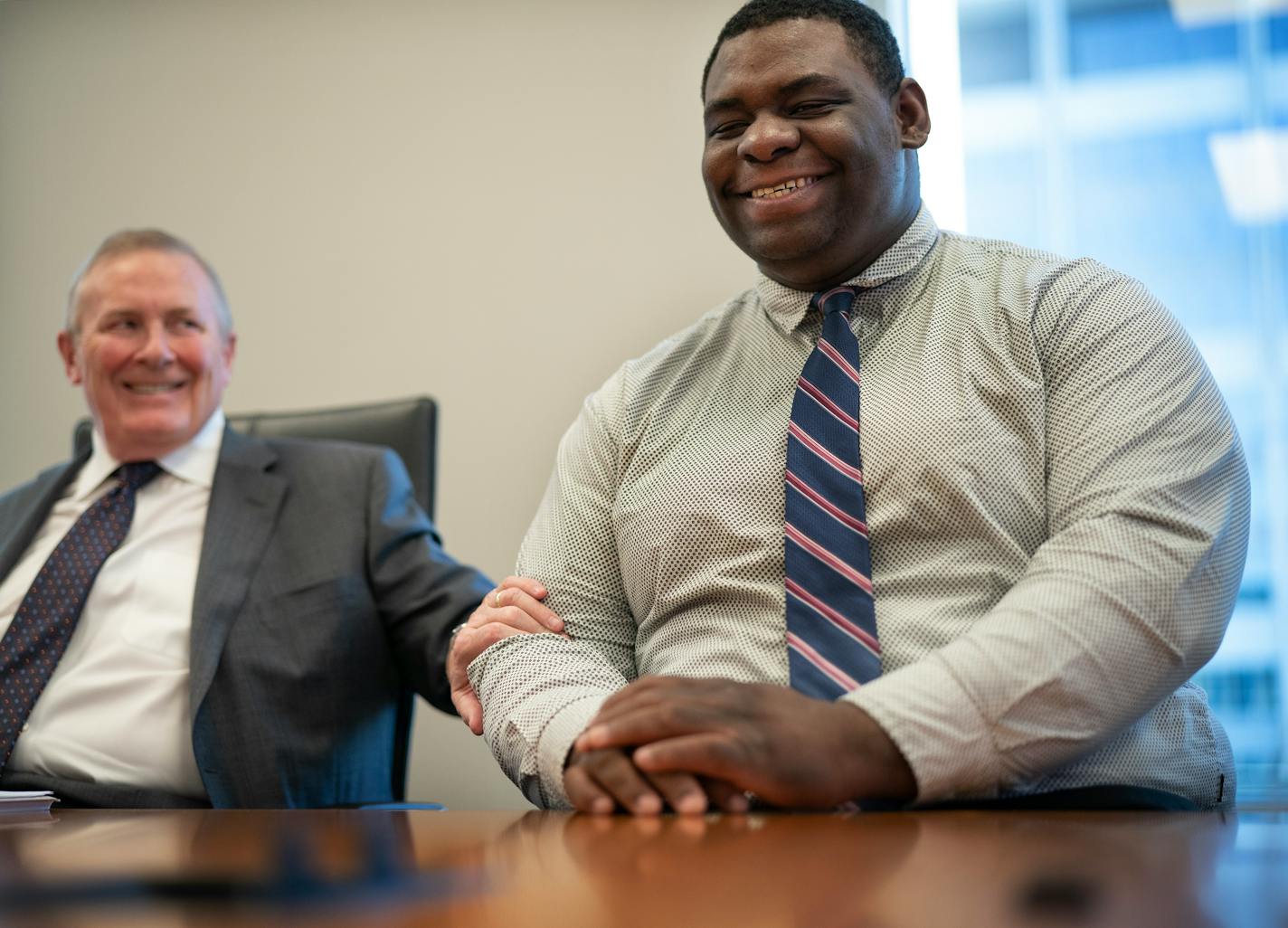 John Pope, right, with his attorney Bob Bennett of Robins Kaplan Law Firm. Pope, now 20, was just 14 years old when former Minneapolis police officer Derek Chauvin placed his knee on his neck during an arrest in 2017. Pope was awarded $7.5 million in a brutality settlement from the city of Minneapolis on Thursday.