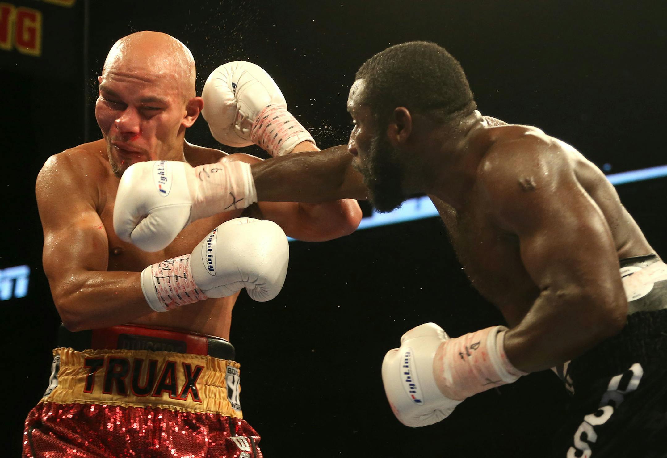 Ossie Duran aka - The Ghanaian Gladiator landed a right hook to the jaw of USBA Middleweight Champion Caleb Truax, of Osseo, Minnesotaduring a semi final fight at Target Center in Minneapolis Friday, January 3, 2014. The bout ended in a tie 95-95. ] (KYNDELL HARKNESS/STAR TRIBUNE) kyndell.harkness@startribune.com