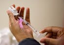 FILE - In this Wednesday, Feb. 7, 2018 file photo, a nurse prepares a flu shot at the Salvation Army in Atlanta. The U.S. government's Friday, Feb. 9,