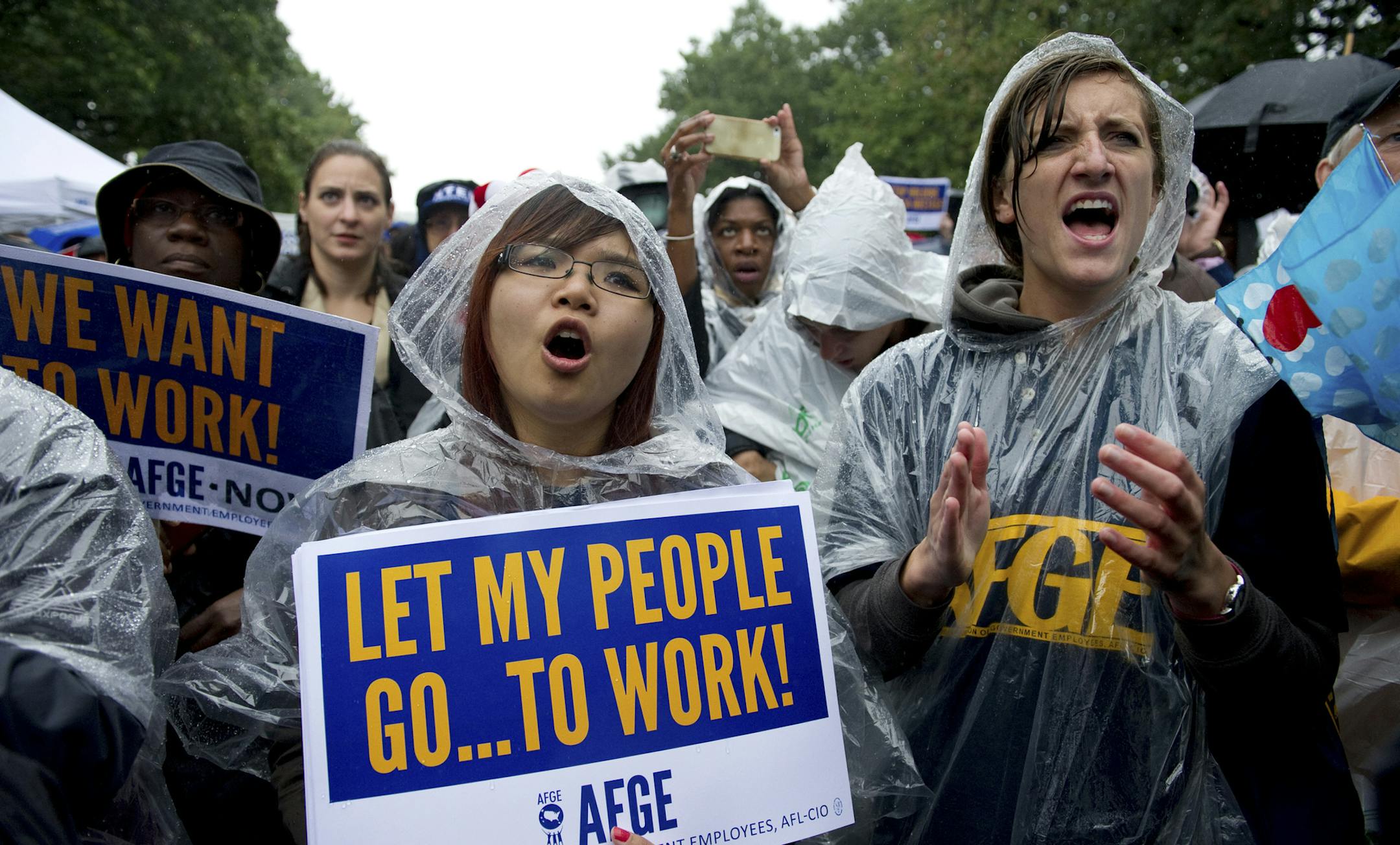 Jennifer Li and Brennan Andrews, both of the American Federation of Government Employees, demonstrate during the "Stop the Lockout" rally against the government shutdown at Upper Senate Park in Washington, Oct. 10, 2013. (Mary F. Calvert/The New York Times) ORG XMIT: MIN2013101117555576