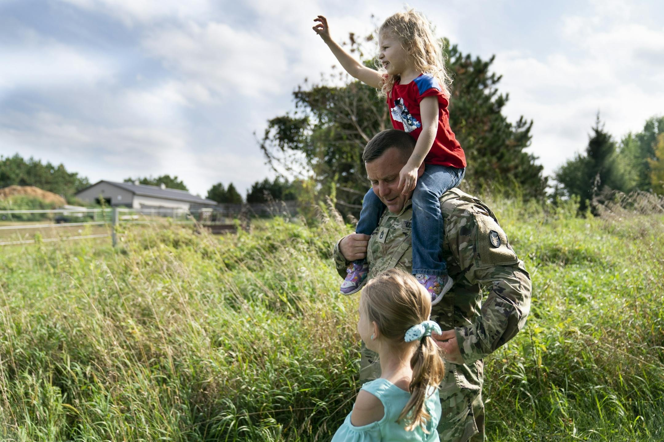 Brian Chafee took his daughters Ally, 3, and Madison, 8, on a walk to see their neighbor's horses in Scandia, Minn., on Wednesday, September 18, 2019. Brian will be taking care of his girls alone as his wife deploys to Iraq for 12 months.