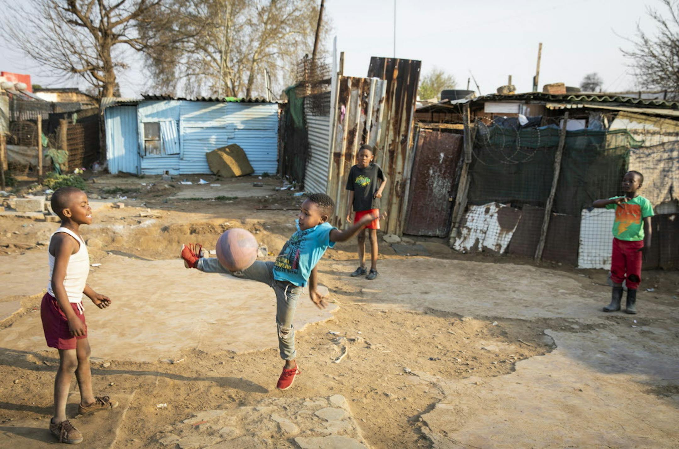 Boys play soccer in a yard in Kliptown, Soweto.