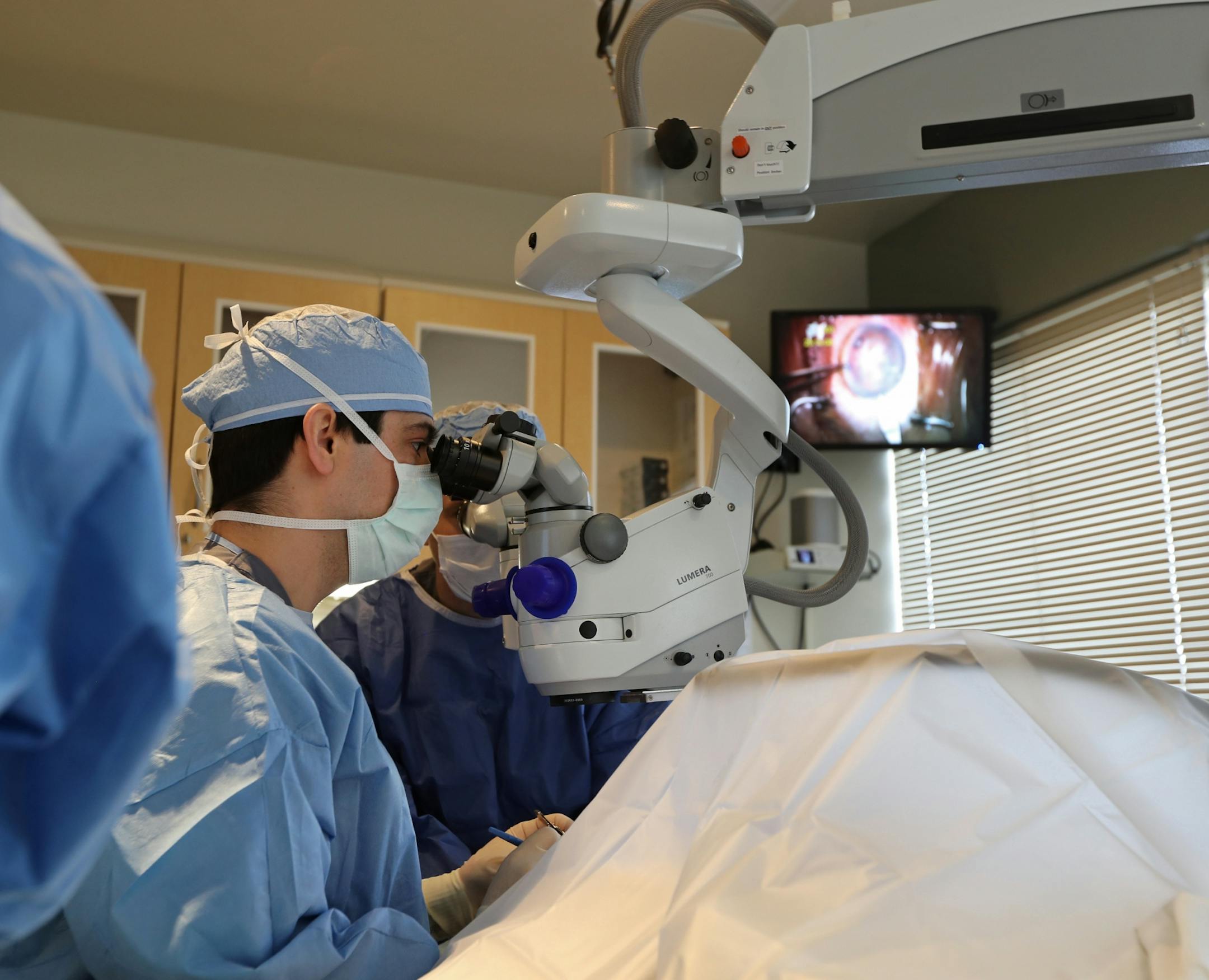 Dr. Walter Parker removed the cataract of an 87-year old patient whose eyesight had been troubling her for several years. The television screen in the upper corner showed the surgery in real time so nurses and assistants in the room are able to monitor the progress of the procedure.