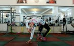 In this Monday, Jan. 18, 2016 photo, Iranian rock climber, Farnaz Esmaeilzadeh, warms up in a gym ahead of rock climbing training session in the city 