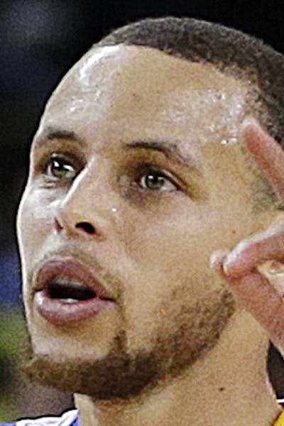Golden State Warriors' Stephen Curry celebrates after scoring against the Utah Jazz during the first half of an NBA basketball game, Sunday, April 7, 