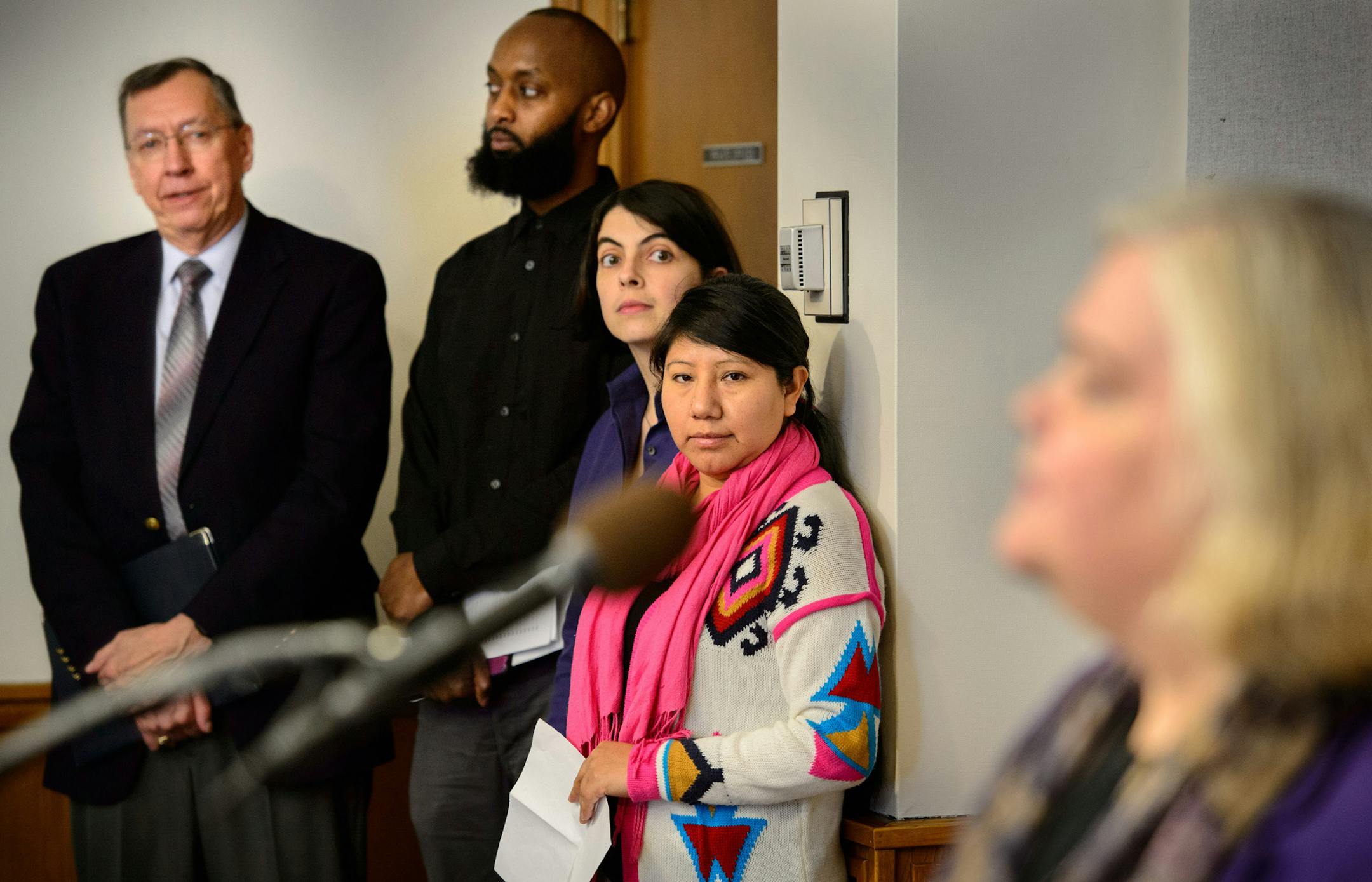 Arnie Bigbee, Edina human rights commission member, Mohamud Mumin, street photographer, and Jovita Morales of Mesa Latina listened as Robin Phillips, executive director, The Advocates for Human Rights talked about the group's new report. Press conference to release report, Moving from Exclusion to Belonging: Immigrant Rights in Minnesota Today, which has recommendations for public policy. ] GLEN STUBBE * gstubbe@startribune.com Wednesday, April 2, 2014.