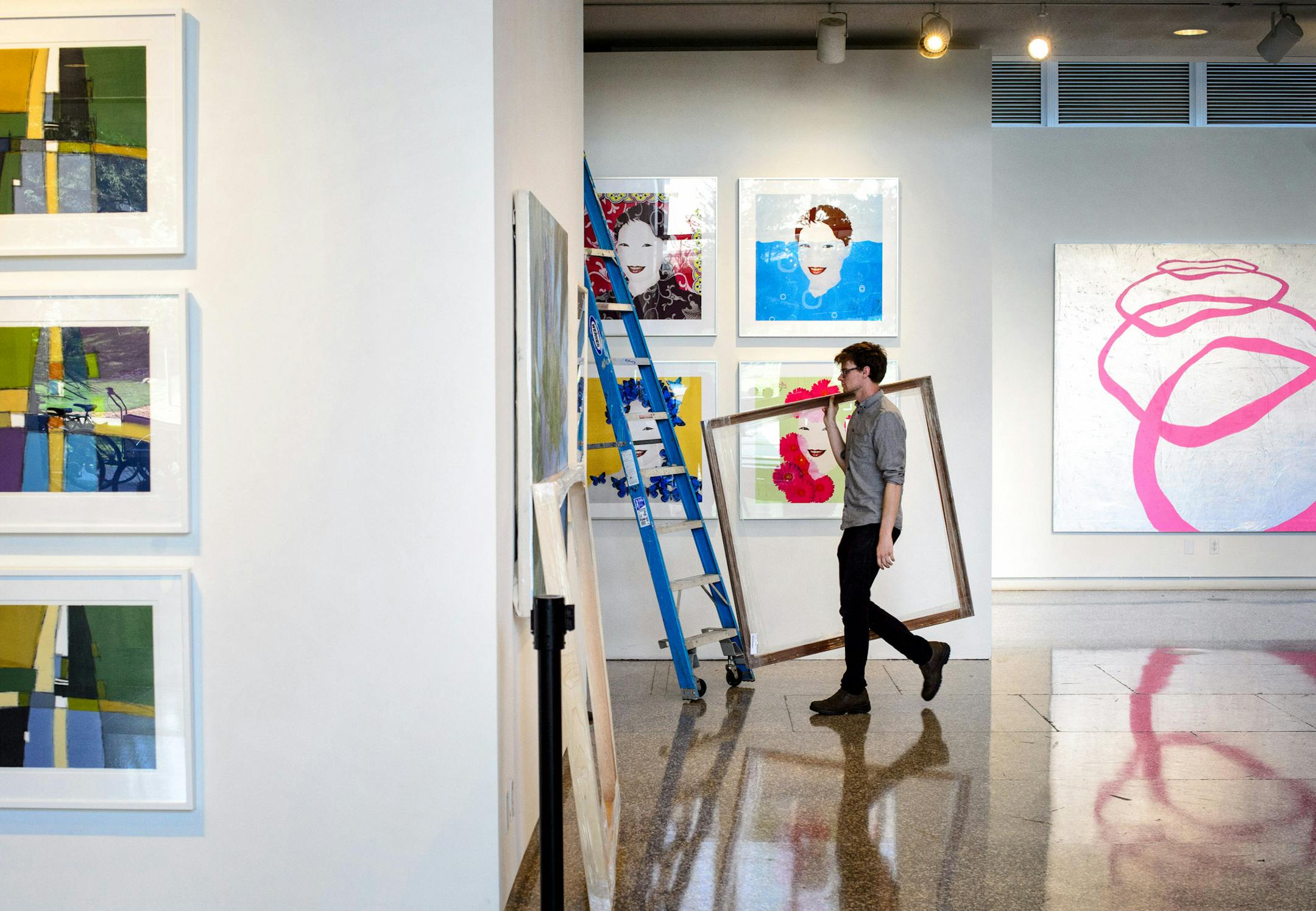 Workers prepared for the MCAD auction. Visible are L to R There Was No Traffic by Toni Dachis '78, China With Love by Tom Garrett '79 and Study for The Mississippi River at Saint Anthony Falls Bridge by Ed Charbonneau '06 for the MCAD auction. ] GLEN STUBBE * gstubbe@startribune.com Wednesday, May 27, 2015 The Minneapolis College of Art & Design is bringing in Christie's to do their annual art auction.