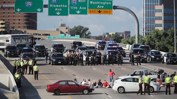 Protesters used vehicles and their bodies to block the southbound lanes of I-35W near the U on Wednesday, July 13, 2016 in Minneapolis. The shutdown l