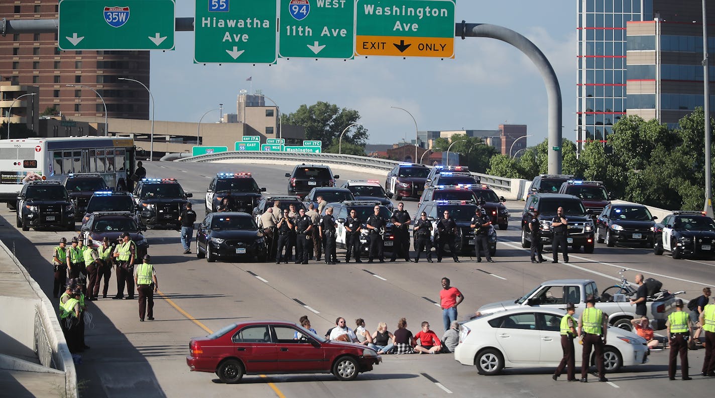 Protesters used vehicles and their bodies to block the southbound lanes of I-35W near the U on Wednesday, July 13, 2016 in Minneapolis. The shutdown lasted about 90 minutes during the morning rush hour.