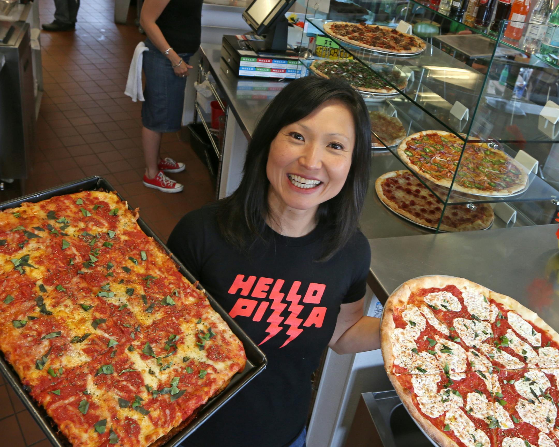 Ann Kim, owner of Hello Pizza in Edina, held a Sicilian pan pie and a Hello Rita pizza, as she was photographed on 6/28/13.] Bruce Bisping/Star Tribune.com bbisping@startribune.com Ann Kim/roster.