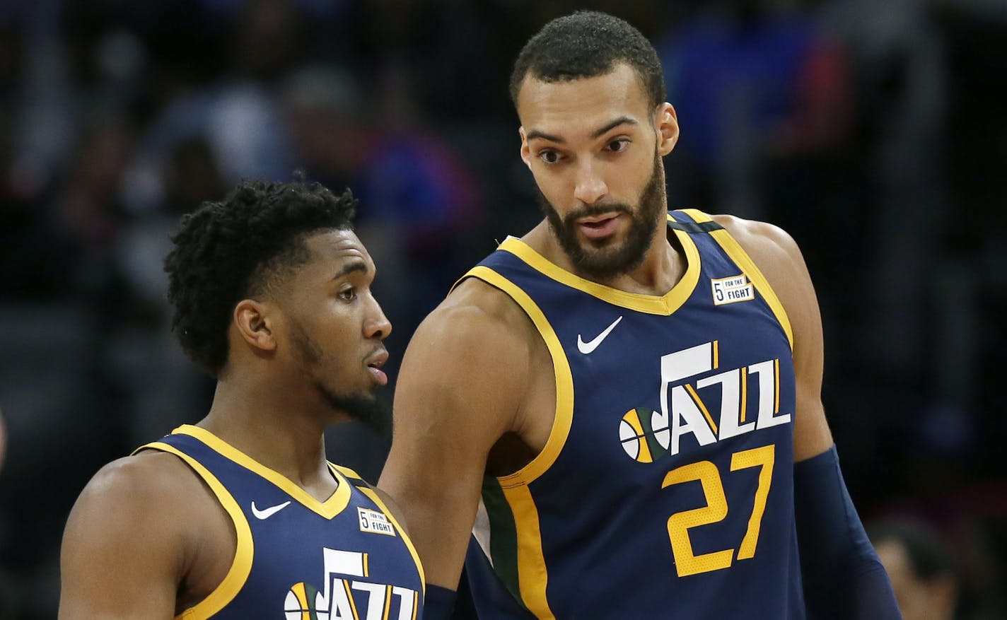 FILE - In this Saturday, March 7, 2020, file photo, Utah Jazz center Rudy Gobert (27) talks with guard Donovan Mitchell, left, during the second half of an NBA basketball game against the Detroit Pistons, in Detroit. Both players have tested positive for the coronavirus. Gobert's test result forced the NBA to suspend the season. (AP Photo/Duane Burleson, File) ORG XMIT: NYDD206